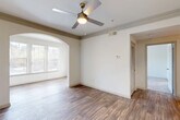 Located at 3378 Greenbriar Pkwy SW in Atlanta, GA, this one-bedroom, one-bathroom residence offers a thoughtfully designed single-floor layout that maximizes functionality and comfort. The living area is a standout, showcasing rich hardwood-style flooring, elegant crown molding, and a ceiling fan with light fixture. A distinctive arched passageway connects the main living space to a bright, windowed alcove — ideal as a dining or flex area — that is bathed in natural light through multiple windows fitted with blinds. The open layout flows naturally toward the entryway, where tile flooring marks the front door, and a pass-through window connects to the kitchen. The kitchen is equipped with white cabinetry, granite-look countertops, black appliances including a refrigerator and dishwasher, and light tile flooring throughout. The bedroom features plush wall-to-wall carpeting, a large window with outdoor views, and access to a dedicated closet. The bathroom includes a vanity with a single sink and granite-look countertop, tile flooring, and ample cabinetry storage. Neutral tones and clean finishes throughout create a bright, cohesive ambiance well-suited for comfortable everyday living.