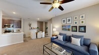 Located at 8800 Bradwell Pl in Fishers, Indiana, this single-floor, 3-bedroom, 2-bathroom home offers a well-designed layout with comfortable living spaces throughout. The open-concept living and dining area is anchored by plush carpet flooring, a ceiling fan, and a sliding glass door that fills the space with natural light. A dedicated dining nook features a slatted wood accent wall, adding a modern touch to the interior.

The kitchen is well-appointed with dark espresso cabinetry, light quartz countertops, a subway tile backsplash, stainless steel appliances, and a deep undermount sink. Wood-look vinyl flooring runs through the kitchen, which also provides direct access to an in-unit utility room housing a full-size washer and dryer.

The spacious primary bedroom features soft carpet, light blue walls, a built-in closet, and a walk-through to additional storage. The two additional bedrooms offer comfortable proportions with ample closet space. Both bathrooms are clean and functional, with one featuring a full tiled tub-surround and wood-look vinyl flooring. A hallway connects all rooms efficiently, completing this thoughtfully laid-out home.