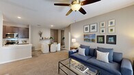 Located at 8800 Bradwell Pl in Fishers, Indiana, this single-floor, 3-bedroom, 2-bathroom home offers a well-designed layout with comfortable living spaces throughout. The open-concept living and dining area is anchored by plush carpet flooring, a ceiling fan, and a sliding glass door that fills the space with natural light. A dedicated dining nook features a slatted wood accent wall, adding a modern touch to the interior.

The kitchen is well-appointed with dark espresso cabinetry, light quartz countertops, a subway tile backsplash, stainless steel appliances, and a deep undermount sink. Wood-look vinyl flooring runs through the kitchen, which also provides direct access to an in-unit utility room housing a full-size washer and dryer.

The spacious primary bedroom features soft carpet, light blue walls, a built-in closet, and a walk-through to additional storage. The two additional bedrooms offer comfortable proportions with ample closet space. Both bathrooms are clean and functional, with one featuring a full tiled tub-surround and wood-look vinyl flooring. A hallway connects all rooms efficiently, completing this thoughtfully laid-out home.