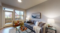 Located at 13400 SE 162nd Ave in Happy Valley, Oregon, this well-appointed single-floor residence offers a thoughtfully designed layout with contemporary finishes and a warm, inviting ambiance. The open-concept living area features warm-toned neutral walls, wood-style flooring, and a large window that frames views of the surrounding neighborhood, filling the space with natural light. The kitchen is a standout feature, outfitted with rich dark cabinetry, granite countertops, a subway tile backsplash, and a full suite of stainless steel appliances including a refrigerator, range, microwave, and dishwasher. A peninsula with a granite overhang accommodates bar seating beneath elegant pendant lighting, creating a seamless connection to the living space. The two bedrooms offer plush carpeting, generous closet storage, and windows that provide natural light and outdoor views. Two bathrooms serve the residence — one featuring a full soaking tub and shower combination, and the other a walk-in shower — both finished with wood-style flooring, granite vanity tops, and dark cabinetry. Clean lines, neutral tones, and modern fixtures throughout contribute to a cohesive and functional living environment.
