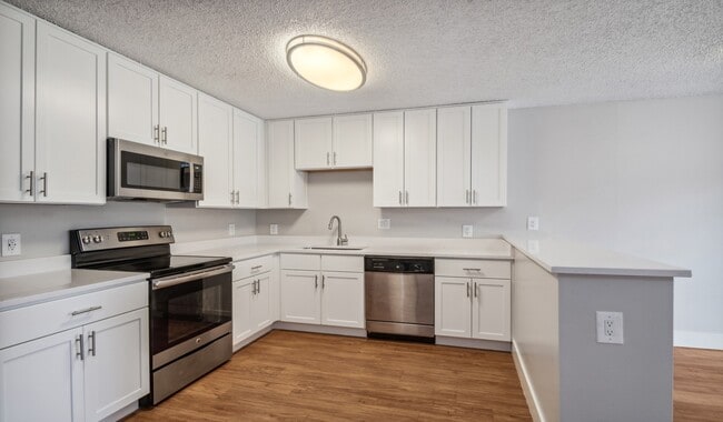 Kitchens offer stainless steel appliances and wood flooring - Meadow Creek
