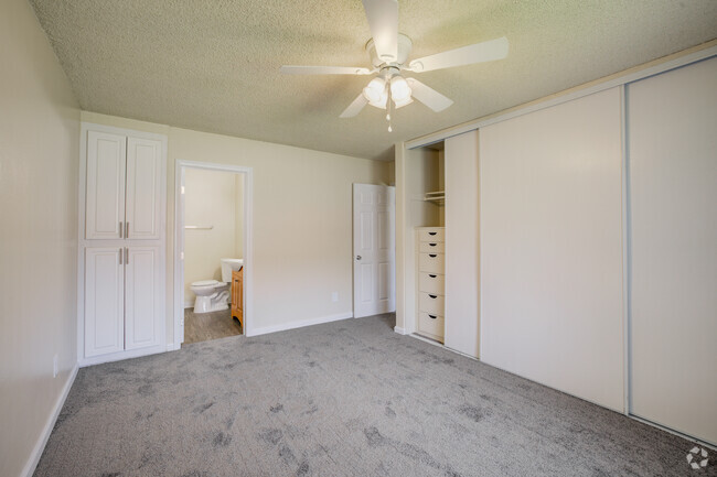 Primary Bedroom and Bathroom - University Village Apartments