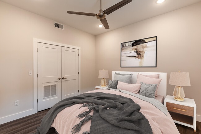 Bedroom with double closet and fan. - 722 E McMillan St