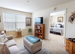 Located at 12910 Dorman Rd in Pineville, NC, this single-floor, one-bedroom, one-bathroom unit offers a practical and well-organized layout across a compact footprint. The living room is a welcoming space featuring carpet flooring, a large window with blinds that allows natural light to fill the room, and enough space for comfortable seating and a work area. A partial wall neatly separates the living area from the kitchen, which includes a full-size refrigerator, sink, and cabinetry with countertop space — all finished with wood-style flooring for easy maintenance. The bedroom is a cozy, carpeted retreat benefiting from its own window with blinds, providing natural light and privacy. Two closets offer functional storage solutions throughout the unit. The bathroom features wood-style flooring, a wall-mounted sink, a mirrored medicine cabinet, and a shower with a curtain enclosure. Accessibility features such as grab bars are also present in the bathroom. Warm, neutral wall tones are consistent throughout the unit, contributing to a calm and cohesive ambiance. This efficiently designed space makes thoughtful use of every square foot, offering a comfortable living environment in Pineville, NC.