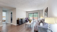 Located at 314 Echelon Rd in Voorhees, NJ, this thoughtfully designed one-bedroom, one-bathroom residence offers a comfortable and efficient single-floor layout. The welcoming entrance opens to a combined living and dining area finished with warm hardwood-style flooring throughout. The living room is bright and airy, anchored by large sliding glass doors that lead to a private balcony with lush tree views, filling the space with natural light. The adjacent dining area features a ceiling fan and neutral tones, creating a relaxed atmosphere for everyday living. The kitchen is well-equipped with rich dark cabinetry, white countertops, a gray subway tile backsplash, stainless steel appliances including a dishwasher, and a window overlooking greenery. The spacious primary bedroom is carpeted for comfort, offers a large closet, and includes a window with outdoor views. The full bathroom features a white vanity with modern brushed nickel fixtures, a mirrored medicine cabinet, and tile flooring. A dedicated in-unit laundry room houses a full-size front-loading washer and dryer. The overall aesthetic is clean, modern, and neutral throughout.