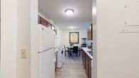 Located at 2150 Wilson Ave in Saint Paul, MN, this one-bedroom, one-bathroom residence offers a well-organized single-floor layout designed for comfortable everyday living. The open-concept kitchen and living area serves as the heart of the home, with the kitchen featuring rich dark brown cabinetry, white appliances including a full-size refrigerator, electric range, and dishwasher, complemented by light countertops and wood-look flooring that extends throughout. A dedicated dining area sits just off the kitchen, creating a natural flow for entertaining or casual meals. The living room is generously proportioned, with soft carpeting, neutral walls, and a large sliding glass door that opens to a private balcony overlooking greenery, filling the space with natural light. The bedroom offers a comfortable retreat with carpeted flooring, a wide window with outdoor views, and a sliding-door closet providing convenient storage. Two additional closets elsewhere in the unit offer exceptional storage capacity. The full bathroom is clean and functional, featuring a tub-shower combination, wood-look tile flooring, and a dark-toned vanity with ample counter space. Throughout, textured ceilings and a neutral color palette create a cohesive, inviting atmosphere well-suited for single occupancy or a couple.