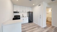 Located at 3101 Sappington Pl in Fort Worth, TX, this efficient one-bedroom, one-bathroom unit offers a thoughtfully designed layout across a single floor. Light wood-look luxury vinyl plank flooring runs throughout the space, creating a cohesive and clean aesthetic.

The kitchen is a standout feature, outfitted with crisp white shaker cabinetry extending to the ceiling for ample storage, black stainless steel appliances including a gas range and full-size refrigerator, a single-basin sink, and a compact peninsula countertop that adds additional prep space. Recessed lighting and a dedicated entry door add both function and polish to this area.

The bedroom is bright and airy, benefiting from a window dressed with white horizontal blinds that invite natural light while maintaining privacy. A ceiling fan with a light fixture provides year-round comfort, and the room includes access to a dedicated closet for storage.

The bathroom is clean and functional, featuring a full tub-shower combination with a white surround, a matte black showerhead and faucet fixtures, and a toilet. The design is simple and well-maintained.

Throughout the unit, crisp white walls, white trim, and consistent flooring tie each room together for a modern, move-in-ready feel.