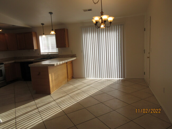 dining area with slider to fenced backyard - 12609 W 10th Ave