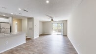 Located at 1900 Windsor Hill Dr in Matthews, NC, this 2-bedroom, 3-bathroom single-floor home offers a thoughtfully designed layout that maximizes comfort and functionality. The open-concept living room features light hardwood-style flooring, a ceiling fan, textured ceilings, and a sliding glass door that floods the space with natural light and provides direct access to a private patio with outdoor views.

The kitchen is well-appointed with white shaker cabinetry, granite-style countertops, stainless steel appliances including a gas range and refrigerator, a double sink, and recessed lighting. A breakfast bar peninsula connects the kitchen to the main living area, making it ideal for both cooking and entertaining.

Both bedrooms are carpeted and include ceiling fans or overhead lighting and windows with blinds that allow for natural light. The primary bedroom is generously sized and includes direct access to a private bathroom with a vanity featuring a stone-style countertop and an adjoining walk-in closet with built-in shelving. The bathrooms are clean and functional, with one featuring a full soaking tub and tiled surround. Additional spaces include a laundry area, utility room, and two hallways for seamless circulation throughout the home.