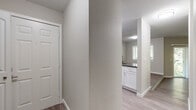 This single-floor residence offers a thoughtfully designed open-concept layout that connects the living areas seamlessly. The spacious living room is finished with durable hardwood-style flooring and features a ceiling fan, large sliding glass door, and multiple windows fitted with plantation shutters, allowing abundant natural light and views of surrounding greenery.

The kitchen is well-equipped with stainless steel appliances, including a refrigerator, range, microwave, and dishwasher. White shaker-style cabinetry pairs with dark countertops, offering a clean, modern contrast. The layout provides ample counter and storage space.

The bedrooms are carpeted for comfort and include ceiling fans and windows that bring in natural light. At least one bedroom connects directly to a bathroom, offering added convenience. The bathrooms feature white cabinetry with dark countertops, hardwood-style flooring, and a tub/shower combination with chrome fixtures.

A dedicated entryway with a closet provides a functional transition into the home. Throughout, a neutral color palette of soft grays and whites creates a cohesive, clean aesthetic, contributing to the space's bright and inviting overall ambiance.
