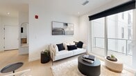 Located at 10318 116 St in Edmonton, AB, this thoughtfully designed 2-bedroom, 2-bathroom unit offers a clean, modern aesthetic throughout. The open-concept main living area seamlessly integrates the kitchen, dining, and living spaces, all finished with light hardwood flooring and crisp white walls that enhance the sense of brightness and space.

The kitchen is a standout feature, boasting warm natural wood cabinetry paired with white upper cabinets, a generous waterfall island with bar seating, white quartz countertops, and stainless steel appliances including a French door refrigerator, built-in range, and over-the-range microwave. The adjacent dining area and living room provide comfortable, well-lit spaces for daily living, with the living room offering access to a private balcony and natural light.

Both bedrooms are well-proportioned and feature light flooring and large windows. The primary bedroom includes a wall-mounted television and direct access to an ensuite bathroom complete with a walk-in shower, wood-toned vanity, and clean tile finishes. The second bathroom features a full soaker tub-shower combination and matching warm wood cabinetry. Additional conveniences include in-unit laundry, a utility room, and ample closet storage throughout.