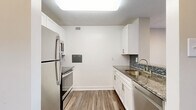 Located on the seventh floor at 4849 Connecticut Ave NW in Washington, DC, this one-bedroom, one-bathroom unit offers a well-organized layout across a single floor. The entry hallway welcomes you in, with a pass-through to the kitchen and access to multiple closets for ample storage throughout the unit. The kitchen is thoughtfully updated, featuring white shaker cabinetry, granite countertops, a mosaic tile backsplash, stainless steel appliances including a refrigerator, range, microwave, and dishwasher, as well as wood-look plank flooring and a skylight-style overhead fixture that keeps the space bright. A peninsula counter opens toward the hallway, creating an efficient flow into the combined dining and living area. The living room benefits from a large floor-to-ceiling window that invites natural light and offers outward views of the surrounding neighborhood. Wood-style flooring extends throughout the main living spaces. The bedroom is a comfortable, private retreat with its own closet and hardwood-style floors. The bathroom includes a full tub and shower combo with white tile surround, maintaining a clean and classic aesthetic. This unit offers practical, modern living in a prime Northwest DC location.