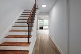 This well-appointed townhouse at 2012 Sheppard Ave W in Toronto offers a thoughtfully designed layout spread across three floors, providing ample space for comfortable living. Light-toned hardwood flooring flows consistently throughout the home, lending a clean, cohesive feel to every room.

The main floor welcomes you with a bright entry hallway, a generous living room filled with natural light from large windows overlooking a private outdoor area, and an open passage to the kitchen. The kitchen is outfitted with crisp white shaker cabinetry, granite-style countertops, a subway tile backsplash, and stainless steel appliances, with a wide window that brings in abundant natural light.

Staircases with warm wood treads and metal railings connect all three levels efficiently. The upper floors house four well-sized bedrooms, each finished with the same light hardwood flooring and windows offering outdoor views of trees and surrounding greenery. The primary bedroom is notably spacious, while additional bedrooms feature built-in closets with double doors for convenient storage.

The two bathrooms are finished with large-format tile flooring, white vanity cabinetry with granite countertops, and full tub-shower combinations. A utility room and additional storage spaces complete the home's practical offerings, making this townhouse a functional and attractive residence.
