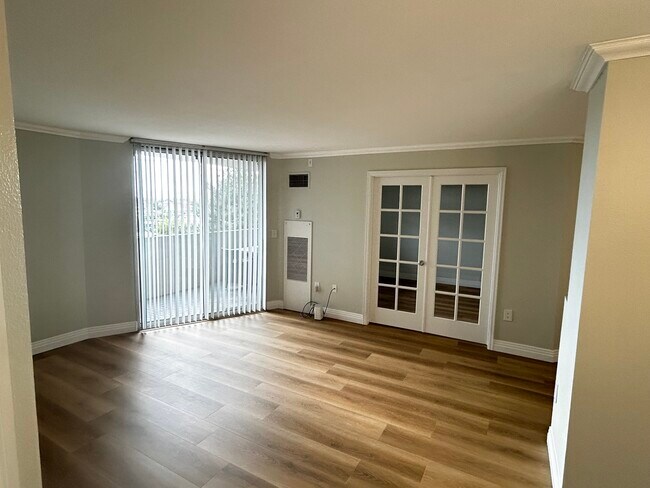 Living Area with french doors to second bedroom - 601 W 11th Ave
