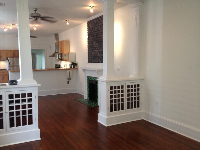 living and dining area with original display cabinet and columns - 4429 S Prieur St