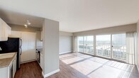 Located at 415 Washington Blvd in Marina del Rey, this single-floor residence offers a well-designed layout with a thoughtful blend of comfort and functionality. The open-concept living and dining area is bathed in natural light, courtesy of expansive sliding glass doors that lead to a private balcony showcasing panoramic views of the surrounding Los Angeles cityscape. Rich hardwood-style flooring runs throughout the main living spaces, adding warmth and visual continuity.

The kitchen is efficiently arranged with white cabinetry, granite-style countertops, a deep double-basin sink, and a pass-through window that connects seamlessly to the living area — ideal for an open, communicative layout. Appliances include a refrigerator and dishwasher.

The bedroom features plush carpeting, generous natural light, and a full wall of mirrored sliding closet doors that enhance the sense of space. A second carpeted room offers additional flexibility. The hallway connects the living areas to the bathroom, which is finished with hardwood-style flooring, a granite-topped vanity with white cabinetry, a full soaking tub, and recessed lighting. A dedicated entry hallway with additional closet access completes the thoughtfully organized floor plan.