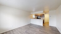 Located at 6285 Ivywood Dr in Portage, Michigan, this efficiently designed single-floor unit offers a well-organized layout that maximizes every square foot. The open-concept living and kitchen area forms the heart of the space, where a peninsula counter separates the two zones while maintaining a connected, airy feel. The kitchen is well-appointed with rich dark-brown cabinetry, light countertops, a double-basin stainless steel sink, and a full suite of stainless steel appliances including a refrigerator, electric range, and over-the-range microwave. A window above the sink allows natural light to filter in, brightening the galley-style workspace. The living area is clean and open, featuring light gray wood-look flooring that runs continuously throughout the unit, contributing to a cohesive and modern aesthetic. Bright white walls and neutral tones create a crisp, move-in-ready atmosphere. A separate room with a window overlooking the outdoors offers flexibility as a bedroom or office. The full bathroom includes a tub/shower combination and a vanity. Two closets provide practical storage. Overall, the unit delivers a functional, well-lit living environment with a clean, contemporary feel.