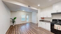 Located at 2700 N Hayden Pkwy in Roseville, CA, this single-story, 3-bedroom, 2-bathroom home offers a clean, modern design with a thoughtfully planned layout. Rich wood-look flooring flows consistently throughout the entire residence, creating a cohesive and inviting atmosphere.

The open-concept living area connects seamlessly to the kitchen, which serves as a functional centerpiece of the home. The kitchen is outfitted with crisp white shaker-style cabinetry, dark countertops, a full suite of black appliances including a gas range, refrigerator, and dishwasher, and a deep sink — all topped with recessed lighting overhead.

Each of the three bedrooms features the same warm wood-look flooring, neutral walls, and windows fitted with blinds that allow for natural light while maintaining privacy. The spacious primary bedroom includes a dedicated closet and connects to the hallway. The additional bedrooms are well-proportioned, each offering closet storage.

Both bathrooms are finished in a clean, minimal style with white cabinetry, dark countertops, and a tub-shower combination. The overall aesthetic throughout the home is bright and contemporary, with white walls, recessed lighting, and a consistent design language that lends the space a fresh, move-in-ready appeal.