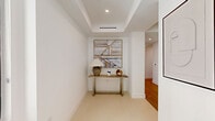 Located in the prestigious community of Coral Gables, Florida, this generously proportioned 4-bedroom, 5-bathroom residence offers a refined modern living experience across a single, thoughtfully designed floor. Light wood flooring flows throughout, lending warmth and continuity to the open-concept layout.

The expansive living room is bathed in natural light from large floor-to-ceiling windows that frame sweeping views of the surrounding cityscape. The adjoining dining area features the same dramatic glazing, creating a bright, airy ambiance ideal for entertaining. The kitchen is a study in minimalist design, with sleek all-white cabinetry, integrated high-end appliances, and clean continuous countertops running along both sides.

The generously sized primary bedroom offers a serene retreat with large windows, warm wood flooring, and access to well-appointed closet space. Three additional bedrooms are equally well-lit, each with dedicated closet storage. The five bathrooms maintain the residence's clean aesthetic, featuring white vanities, glass-enclosed showers, and soaking tubs in select bathrooms.

Four hallways connect the residence's distinct zones with ease, while a dedicated utility room and three closets provide ample storage. The overall design palette—neutral tones, natural light, and premium finishes—creates a cohesive, sophisticated atmosphere throughout.