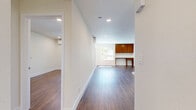 Located at 16550 Vanowen St in Van Nuys, Los Angeles, this well-appointed one-bedroom, one-bathroom unit offers a thoughtfully designed single-floor layout. Warm hardwood-style flooring runs throughout the entire space, creating a cohesive and inviting atmosphere.

The open-concept living and kitchen area forms the heart of the unit. The kitchen is equipped with stainless steel appliances — including a gas range, dishwasher, and full-size refrigerator — complemented by white cabinetry, a clean countertop with an integrated sink, and a peninsula that opens toward the living space. Recessed lighting illuminates the area throughout.

The bedroom is a comfortable, well-proportioned retreat featuring a wall-mounted mini-split air conditioning unit, a window with views of surrounding greenery, and mirrored sliding closet doors that add depth and reflect natural light. A built-in desk with upper cabinetry in warm wood tones provides a dedicated workspace, making the room highly functional.

The bathroom is clean and modern, featuring a full tub-shower combination with brushed nickel fixtures, a white vanity with drawer storage, and matching hardwood-style flooring that ties the space together seamlessly.

Crisp white walls, recessed lighting, and consistent flooring throughout give the unit a fresh, move-in-ready feel.
