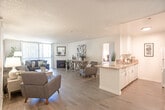 Located at 424 Kelton Ave in the heart of Westwood, Los Angeles, this single-story unit offers a well-designed, open-concept layout that seamlessly connects the primary living spaces. The spacious living room features hardwood-style flooring, a fireplace, and large vertical-blind-covered windows that invite natural light, creating a bright and comfortable atmosphere. A dedicated seating area flows naturally into a separate dining space, which is accented by a ceiling fan and a warm wood-tone entry door.

The kitchen is efficiently laid out with white cabinetry, a granite-style countertop peninsula, white appliances including a gas range and refrigerator, and direct sightlines into the main living area — ideal for both everyday living and entertaining.

Both bedrooms are generously proportioned, each featuring hardwood-style flooring, large windows for natural light, and ample wall space for furnishings. The two bathrooms are finished with granite-style countertops, large mirrors, and clean white fixtures. One bathroom features white cabinetry, adding additional storage.

Throughout the unit, a neutral color palette and consistent flooring create a cohesive, move-in-ready aesthetic well-suited for comfortable urban living in one of Los Angeles's most sought-after neighborhoods.