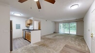 Located at 529 Sandpiper Ln in Wadsworth, Ohio, this single-floor, three-bedroom, one-bathroom home offers a practical and comfortable layout. The open-concept kitchen and living area serves as the heart of the home, where light wood cabinetry, dark granite-style countertops, a stainless steel refrigerator, range, and dishwasher combine with a peninsula-style breakfast bar. The kitchen features durable wood-look vinyl flooring, while the adjacent living room is carpeted and anchored by a ceiling fan. Large sliding glass doors fill the living area with natural light and provide views of lush greenery outdoors. A hallway connects the main living spaces to the three carpeted bedrooms, each equipped with ceiling fans. The primary bedroom is a comfortable size and includes a dedicated closet with built-in wire shelving, while at least one additional bedroom features a sliding wood-door closet and a window overlooking the outdoors. The full bathroom includes a wood-vanity with sink, a tub/shower combination, and hexagonal tile flooring. A walk-in closet with extensive wire shelving adds additional storage. The home's clean, neutral palette and consistent finishes throughout create a cohesive and move-in ready living environment.