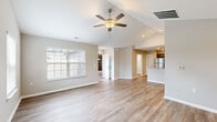 Located at 9060 Heirloom Ln. in Reynoldsburg, Ohio, this single-floor home offers a well-designed layout with two bedrooms, two bathrooms, a dedicated laundry room, and an attached garage. The open-concept living area features vaulted ceilings, a ceiling fan, recessed lighting, and light-toned hardwood-style flooring that runs throughout the main living spaces, creating a bright and cohesive feel. A large window floods the living room with natural light, while a pass-through view connects seamlessly to the kitchen.

The kitchen is equipped with dark espresso shaker-style cabinetry, granite countertops, and a full suite of stainless steel appliances, including a refrigerator, range, and microwave. Recessed lighting and wood-look flooring complete the space.

The primary bedroom features vaulted ceilings, dual windows for ample natural light, and hardwood-style flooring. The second bedroom offers plush carpeting, a natural light window, and a sliding-door closet with wire shelving. Both bathrooms feature marble-style tile flooring; the primary bath includes a glass-enclosed shower and granite vanity, while the second bath offers a tub-shower combo. The laundry room includes washer and dryer hookups and overhead wire shelving. The spacious attached garage provides generous storage and parking capacity.