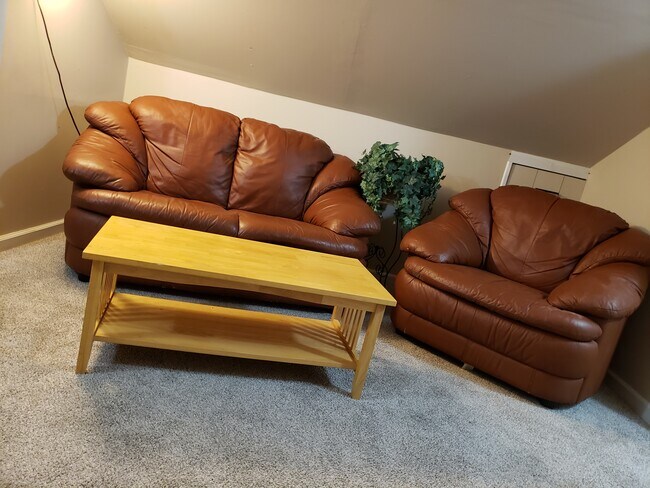 Leather chair and loveseat with coffee table. - 421 S Talley Ave