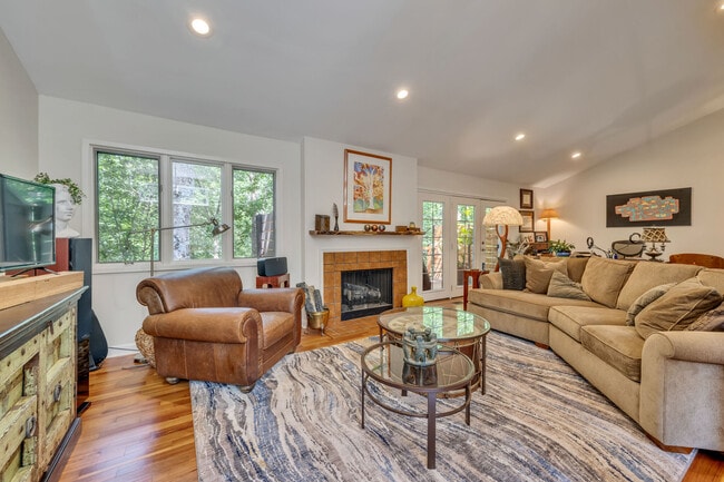 Open living room with lots of windows. Access to private deck that looks onto wooded common area. - 918 Harpeth Trace Dr