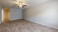 Located at 1202 Old Lascassas Rd in Murfreesboro, TN, this single-story, 2-bedroom, 2-bathroom home offers a practical and well-organized layout across a comfortably sized floor plan. The living room serves as the welcoming heart of the home, featuring wood-look laminate flooring, a ceiling fan, a textured ceiling, and a window that draws in natural light alongside the front entry door. The kitchen area is visible in the dollhouse view, positioned centrally with white cabinetry and open access to the living spaces. Both bedrooms are carpeted and equipped with ceiling fans, offering a cozy atmosphere. The spacious primary bedroom features two windows for enhanced natural light and ventilation. The second bedroom includes a closet with bifold doors. Both bathrooms are finished with wood-look tile flooring and white vanity cabinetry. Each bathroom includes a tub/shower combo with a white surround and brushed nickel fixtures. A hallway connects the private areas of the home, while two closets and a dedicated utility room add practical storage and functional space. Neutral wall tones and consistent finishes throughout give the home a clean, cohesive aesthetic.