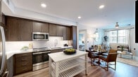 Located in Scottsdale, Arizona, this thoughtfully designed 2-bedroom, 2-bathroom residence offers a seamless blend of modern style and everyday functionality across a single floor. The open-concept kitchen and living area serves as the heart of the home, featuring rich dark-wood cabinetry, stainless steel appliances, white quartz countertops, a tile backsplash, and a freestanding kitchen island with additional storage. Light wood-style flooring extends throughout the main living areas, complementing the neutral, contemporary palette. The living room is bright and inviting, with multiple windows dressed in blinds and sheer curtains, a sliding glass door leading to a private balcony, and clean white walls that enhance the sense of openness. Both bedrooms are carpeted and well-lit by large windows, with the primary bedroom offering a spacious layout and dedicated closet with built-in shelving and hanging rods. Each bathroom is finished with neutral tile, dark wood vanities, and white countertops, with one bathroom featuring a soaking tub and shower combination. A connecting hallway and two closets provide practical storage throughout. The overall ambiance is clean, modern, and cohesive, making this Scottsdale residence a comfortable and stylish living space.