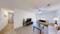 Located at 6230 Abbotts Park Dr in Fayetteville, NC, this single-story, 2-bedroom, 1-bathroom home offers a thoughtfully designed layout that maximizes comfort and functionality. The open-concept living room is bright and welcoming, featuring light wood-style flooring, a textured ceiling, and a ceiling fan. Large windows allow natural light to fill the space, offering views of the outdoors. The kitchen is equipped with warm wood cabinetry, granite-style countertops, a peninsula with breakfast bar seating, and white appliances including a refrigerator and built-in microwave. Track lighting overhead keeps the workspace well-lit. The primary bedroom is generously sized, finished with plush carpet flooring, a ceiling fan, and a window that brings in natural light. It provides ample space for full-sized furniture. The second bedroom offers similar finishes and comfort. A dedicated walk-in closet features wire shelving for organized storage. The bathroom includes a wood-toned vanity topped with a granite-style countertop and a framed mirror. Throughout the home, a consistent neutral color palette and clean finishes create a cohesive and inviting ambiance, making it a practical and comfortable residence.