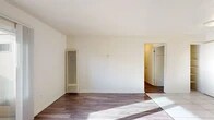 Located at 4550 Shelley Ct in Stockton, California, this single-floor unit offers a clean, functional layout ideal for comfortable everyday living. The interior features rich wood-look flooring throughout the main living areas, complemented by bright white walls that create a light and airy atmosphere.

The living area is generously proportioned, bathed in natural light that streams in through a sliding glass door leading to a private enclosed patio — a convenient outdoor extension of the living space. A wall-mounted heating unit and a window air conditioning unit provide year-round climate control.

The kitchen is efficiently designed with white cabinetry offering ample storage, dark granite-style countertops, a white electric range, and a refrigerator. Light ceramic tile flooring and a window allow natural light to brighten the space.

The bedroom is well-sized with the same wood-look flooring, generous natural light, and direct access to a spacious walk-in closet outfitted with wraparound shelving and hanging rods for abundant storage.

The bathroom features a full tub-shower combination with neutral, textured wall tile and chrome fixtures, providing a clean and polished finish. The overall layout, as revealed by the floor plan, is compact yet thoughtfully arranged to maximize usability across every room.