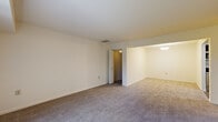 Located at 2000 Maplewood Drive in York, PA, this single-floor, 2-bedroom, 1-bathroom residence offers a functional and well-organized layout. The living area is finished with neutral wall-to-wall carpeting and features large vertical-blind windows that invite natural light and provide outdoor views of the surrounding greenery. A pendant light fixture adds a finishing touch to the adjoining space, which flows seamlessly through an open pass-through layout.

The kitchen is a standout feature, equipped with rich dark-wood shaker-style cabinetry, granite-look countertops, a stainless steel refrigerator, dishwasher, and gas range, all complemented by light hardwood-style flooring. It offers an efficient and stylish workspace for daily use.

The spacious primary bedroom includes plush carpeting and a built-in closet with bi-fold doors, providing ample storage. The second bedroom is equally comfortable with similar finishes. Both rooms are connected via hallways that guide traffic through the residence.

The bathroom is clean and bright, featuring white tile surrounding a full bathtub and shower, a vanity with white cabinetry, and wood-look flooring. The overall aesthetic throughout is neutral and move-in ready, offering a cohesive and practical living environment.