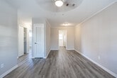Located at 600 Arizona Ave in Warner Robins, Georgia, this single-story home offers five bedrooms, one bathroom, a living room, and a kitchen — all unified by light-toned luxury vinyl plank flooring that runs consistently throughout the entire layout. The neutral warm-gray walls and white trim create a clean, cohesive aesthetic across every room.

The bedrooms vary slightly in size and configuration, with several featuring sliding-door closets offering built-in shelving and hanging space. Ceiling fans with light fixtures are present in select bedrooms and the living area, while multiple rooms benefit from natural light through slatted horizontal blinds. Some bedrooms include two windows, enhancing brightness and ventilation.

The kitchen is compact and efficiently designed, featuring white cabinetry, light countertops, a full-size refrigerator, and a rear exterior door with a window that brings in additional natural light. The shared full bathroom is finished with white subway tile surrounding the bathtub and shower, complemented by a window above the tub, a toilet, and a single-sink vanity.

A central hallway connects the rooms throughout the home. The overall design is practical and well-maintained, making efficient use of the available floor space while providing a comfortable, move-in-ready environment.
