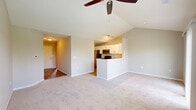 Located at 1503 Finger Lakes in Dayton, Ohio, this well-appointed one-bedroom, one-bathroom home offers a thoughtfully designed layout across a single floor. The open-concept living and kitchen area is anchored by soaring vaulted ceilings with a ceiling fan, creating an airy, expansive feel. Large sliding glass doors flood the living room with natural light and provide direct access to a private deck showcasing stunning views of a tranquil pond surrounded by lush greenery — a true standout feature of this home.

The kitchen is efficiently designed with white cabinetry, granite-look countertops, stainless steel appliances including a refrigerator, range, and over-the-range microwave, and wood-look flooring that extends throughout the wet areas. A peninsula with a sink connects the kitchen to the living space seamlessly.

The bedroom is generously sized, featuring vaulted ceilings, plush carpet, a ceiling fan, and large windows that invite natural light. An arched accent window adds an elegant architectural touch. The bedroom connects to a spacious walk-in closet equipped with multi-tiered wire shelving and hanging rods for ample storage.

The full bathroom is clean and functional, featuring white cabinetry, a tub/shower combo, and wood-look tile flooring. The overall neutral palette and well-maintained finishes throughout create a bright, welcoming ambiance.