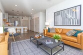 Located at 1850 Duluth Hwy in Lawrenceville, Georgia, this single-floor residence offers a thoughtfully designed layout with contemporary finishes throughout. The open-concept kitchen is a standout feature, showcasing granite countertops, light wood cabinetry with matte black hardware, a subway tile backsplash, and a full suite of stainless steel appliances. A peninsula with bar seating and pendant lighting creates an inviting space for casual dining and entertaining.

The living area is warm and welcoming, with wood-look flooring, a ceiling fan, large windows that admit generous natural light, and a teal accent wall that adds a modern pop of color. The space comfortably accommodates a full seating arrangement and media setup.

The primary bedroom features plush carpeting, a ceiling fan, and ample natural light from well-dressed windows. It connects to a spacious walk-in closet and a private en-suite bathroom finished with granite counters, wood-toned cabinetry, hardwood-style flooring, and a glass-enclosed shower. A second bedroom offers similar comfort, highlighted by a textured accent wall and its own ceiling fan. The second bathroom includes a full tub-shower combination with white subway tile and a granite vanity, maintaining the cohesive, refined aesthetic found throughout the home.