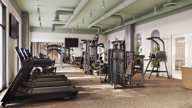 Club-quality fitness studio with TRX station, Peloton bikes, and private training studio. - Modera Academical Village