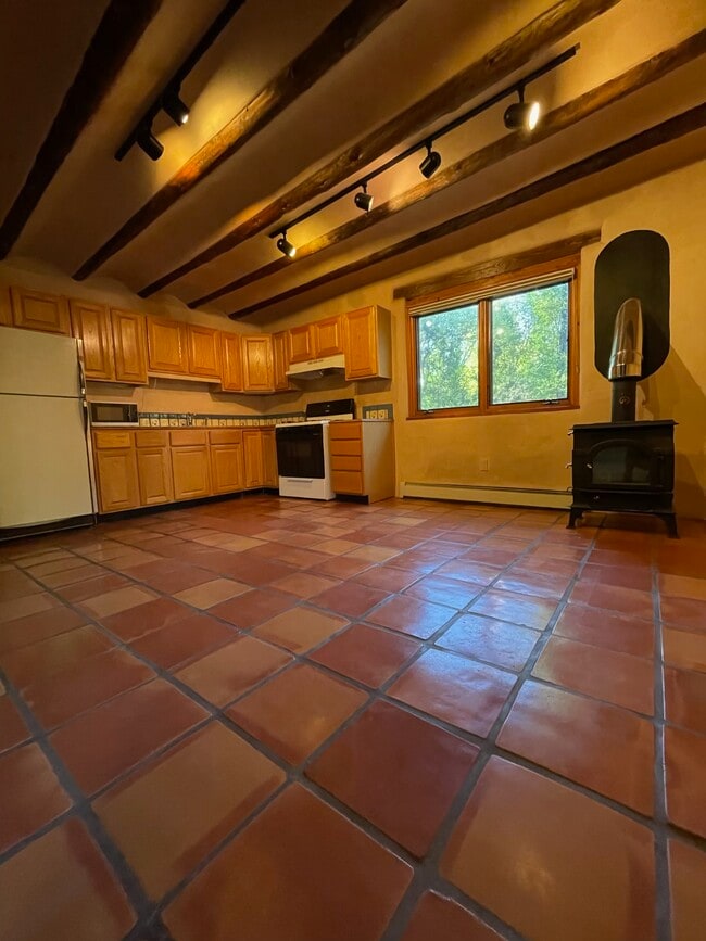 Kitchen and dining area with wood stove - 1470B Bishops Lodge Rd
