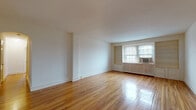 Located at 900 W Montgomery Ave in Bryn Mawr, PA, this single-floor unit offers a well-organized layout with a clean, classic aesthetic throughout. The living areas are distinguished by gleaming hardwood floors that reflect abundant natural light streaming through multi-pane windows. Built-in shelving flanks a set of windows in the main living room, providing both storage and a charming architectural detail. The open wall space throughout offers excellent flexibility for furniture arrangement.

The bedrooms continue the hardwood flooring and are served by generous closet space, including a dedicated closet with shelving. Classic white radiators beneath the windows provide efficient heating, complementing the timeless character of the unit.

The kitchen is equipped with warm wood cabinetry, white appliances including an electric range and dishwasher, a double sink, and light tile flooring. A pantry closet adds practical storage. Adjacent to the kitchen is a dedicated laundry area featuring a stacked washer and dryer unit, additional wood cabinetry, a utility sink, and large windows that bring in natural light.

The bathroom is finished in clean white tile, offering a tub/shower combination, pedestal-style vanity, and a bright window. Neutral tones and classic finishes are consistent throughout, creating a cohesive and functional living space in a desirable Bryn Mawr location.