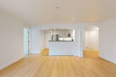 Located along Lake Washington Blvd NE in Kirkland, WA, this well-appointed 3-bedroom, 3-bathroom residence offers a thoughtfully designed single-floor layout. The open-concept living, dining, and kitchen area forms the heart of the home, bathed in natural light from multiple windows and anchored by a classic fireplace with a clean white surround. Light-toned hardwood flooring flows seamlessly throughout the main living spaces, enhancing the bright and airy atmosphere.

The kitchen is equipped with stainless steel appliances, white shaker-style cabinetry, granite countertops, and a peninsula that provides both additional prep space and a natural visual divider from the living area. A dedicated pantry adds practical storage. Elegant arched architectural details and crown molding throughout lend the space a refined character.

The three bedrooms offer comfortable proportions, with the carpeted rooms providing a softer feel. The spacious primary bedroom features natural light from an outdoor-facing window. All three bathrooms are finished with tile flooring, granite-topped white vanities, and clean, modern fixtures. A private balcony extends the living space outdoors. Seven closets ensure generous storage throughout, while a dedicated entrance and hallway complete this well-organized residence.