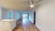 This contemporary 860 square foot apartment in Newport Beach offers a blend of comfort and style. The space features two bedrooms, including a generously sized primary bedroom of 260 square feet, and one bathroom. The single-story layout maximizes living space efficiency.

The kitchen is a highlight, boasting modern appliances including a stainless steel refrigerator and range. White cabinetry contrasts beautifully with the hardwood flooring, creating a bright and inviting cooking area. A peninsula countertop adds extra workspace and potential for casual dining.

Throughout the apartment, hardwood floors lend warmth and elegance to each room. The living area is spacious and well-lit, with a sliding glass door leading to a balcony, providing a seamless indoor-outdoor living experience. Both bedrooms feature ample space and natural light from windows, with one room including a mirrored closet for added functionality.

The bathroom continues the modern aesthetic with a large vanity, ample counter space, and clean lines. The apartment's neutral color palette allows for easy personalization, while the overall design emphasizes openness and light. Climate control is provided by both central heating and a window air conditioning unit, ensuring year-round comfort in this Newport Beach home.