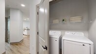 Located at 50 Tanner Rd in Greenville, SC, this 2-bedroom, 2-bathroom residence offers a thoughtfully designed single-floor layout that balances modern aesthetics with everyday functionality. The open-concept living room is bright and welcoming, featuring light hardwood-style flooring, a ceiling fan, and multiple windows dressed with horizontal blinds and sheer white curtains that flood the space with natural light and offer views of the surrounding greenery.

The kitchen is a standout feature, showcasing white shaker cabinetry, grey quartz countertops, stainless steel appliances, a subway tile backsplash, and a central island with bar seating — ideal for both cooking and casual dining. Recessed lighting and hardwood-style floors carry throughout this area seamlessly.

Both bedrooms are carpeted and comfortably sized, each equipped with a ceiling fan, generous windows, and ample closet access. The primary bedroom provides a tranquil retreat with natural light and dedicated closet space. The primary bathroom features a long vanity with white cabinetry, grey countertops, and black hardware accents. The second bathroom offers a full tub-shower combination with white subway tile and matching matte black fixtures. The overall palette is clean, neutral, and modern throughout.