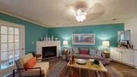Located at 100 Shore Lake Dr in Greensboro, NC, this single-floor residence offers a well-designed layout with a lively, cohesive color palette throughout. The living room serves as the focal point of the home, featuring bold teal accent walls, a white-mantled fireplace, crown molding, a textured ceiling, and durable wood-style flooring — creating a warm and inviting atmosphere. A ceiling fan with a decorative light fixture adds both function and style to the space.

The kitchen is fully equipped with stainless steel appliances, including a refrigerator, dishwasher, microwave, and electric range. White shaker-style cabinetry, granite-look countertops, and wood-style flooring give the kitchen a clean, modern feel with ample storage and counter space.

The bedrooms are carpeted and comfortably sized, with arched windows that allow natural light to fill the rooms. The primary bedroom includes direct access to an en-suite bathroom. The bathrooms feature white cabinetry with generous vanity storage, a tub-shower combination, and wood-style flooring.

A versatile flex room, accessible through a classic French door, offers wood-style flooring, large windows with natural light, and a ceiling fan — ideal for use as a home office or study. The overall ambiance of the residence is cheerful, colorful, and functional.