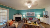 Located at 100 Shore Lake Dr in Greensboro, NC, this single-floor residence offers a well-designed layout with a lively, cohesive color palette throughout. The living room serves as the focal point of the home, featuring bold teal accent walls, a white-mantled fireplace, crown molding, a textured ceiling, and durable wood-style flooring — creating a warm and inviting atmosphere. A ceiling fan with a decorative light fixture adds both function and style to the space.

The kitchen is fully equipped with stainless steel appliances, including a refrigerator, dishwasher, microwave, and electric range. White shaker-style cabinetry, granite-look countertops, and wood-style flooring give the kitchen a clean, modern feel with ample storage and counter space.

The bedrooms are carpeted and comfortably sized, with arched windows that allow natural light to fill the rooms. The primary bedroom includes direct access to an en-suite bathroom. The bathrooms feature white cabinetry with generous vanity storage, a tub-shower combination, and wood-style flooring.

A versatile flex room, accessible through a classic French door, offers wood-style flooring, large windows with natural light, and a ceiling fan — ideal for use as a home office or study. The overall ambiance of the residence is cheerful, colorful, and functional.