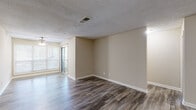 Located at 2696 N Druid Hills Rd NE in Atlanta, Georgia, this single-floor residence offers a well-organized and comfortable layout throughout. The living area is open and inviting, featuring durable hardwood-style flooring, neutral warm-toned walls, and a ceiling fan. Large sliding glass doors allow natural light to fill the space while providing outdoor access. A fireplace serves as a focal point in the main living area, adding warmth and character to the interior.

The galley-style kitchen is efficiently designed with dark cabinetry, granite-style countertops, a decorative tile backsplash, and stainless steel appliances including a refrigerator, range, and microwave. Track lighting overhead ensures bright, functional illumination. The kitchen connects seamlessly to the rest of the unit.

Bedrooms are carpeted for comfort and include ceiling fans and windows that bring in natural light. A generously sized walk-in closet with wire shelving provides ample storage. The bathrooms feature clean, white tiled tub-and-shower combos with chrome fixtures and framed mirrors.

A dedicated in-unit laundry area houses a full-size washer and dryer. Textured ceilings and crisp white crown molding and baseboards add a finished touch throughout, creating a cohesive and practical living environment.