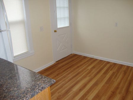 Kitchen from doorway off living room, next to closet. Door leads to deck. - 522 E Market St