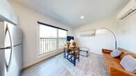 Located at 343 Mt Support Rd in Lebanon, NH, this thoughtfully designed one-bedroom, one-bathroom unit offers a clean, modern aesthetic throughout its single-floor layout. Light wood-look flooring and crisp white walls create a bright, cohesive atmosphere across all rooms.

The open living area is anchored by a large sliding glass door that leads to a private balcony, flooding the space with natural light and offering elevated views of the surrounding landscape. The kitchen is well-appointed with white shaker cabinetry, dark countertops, subway tile backsplash, and a full suite of stainless steel appliances, including a range, microwave, dishwasher, and refrigerator. A built-in counter nook provides additional prep or workspace.

A hallway connects the main living area to the private bedroom, which features clean white walls, recessed lighting, and access to a closet. The bathroom includes a glass-enclosed walk-in shower finished with white subway tile and brushed nickel hardware. In-unit laundry is conveniently tucked behind a dedicated closet off the hallway. Two closets provide ample storage. A bold red accent door frame adds a distinctive modern touch to the interior design, making this a well-considered and functional living space.