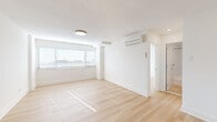 Located at 3201 Wisconsin Ave NW in Washington, DC's desirable upper Northwest corridor, this thoughtfully updated unit offers a clean, modern aesthetic across a single-floor layout. Light-toned hardwood flooring flows seamlessly throughout the living and bedroom spaces, reflecting natural light and contributing to the home's open, airy feel. Large windows fitted with horizontal blinds allow ample daylight into the generously sized living area, which also features a wall-mounted ductless mini-split system for efficient climate control. The galley-style kitchen is well-appointed with crisp white shaker cabinetry, quartz countertops, a classic subway tile backsplash, light tile flooring, and a full suite of stainless steel appliances including a gas range, built-in microwave, and dishwasher. The bedroom offers a comfortable footprint with a closet and good natural light. The bathroom is finished with large-format white wall tiles, a soaking tub, and modern chrome fixtures, maintaining the home's consistent, clean palette. Throughout the unit, bright white walls and minimalist finishes create a cohesive, contemporary atmosphere that is both functional and inviting.