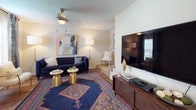 This two-story residence offers a well-organized layout across its multiple rooms, combining practical design with comfortable living spaces. The kitchen is efficiently arranged with warm oak cabinetry, dark granite-style countertops, and tile flooring. A built-in chalkboard wall adds a functional and creative touch near the kitchen entry, while a window provides natural light. Appliances include an electric range, built-in microwave, and dishwasher, with ample cabinet storage throughout.

The living area features hardwood-style flooring, a ceiling fan with integrated lighting, and a staircase leading to the upper level, creating an open and connected flow between floors. Natural light filters in through a window, enhancing the room's welcoming ambiance.

The bedrooms are carpeted and well-proportioned, each featuring windows dressed with curtains that allow for natural light and privacy. Ceiling fans are present in select bedrooms. The neutral wall tones throughout provide a versatile backdrop adaptable to various décor styles. Each bedroom offers comfortable proportions with sufficient space for furnishings, making this residence a practical and livable home.